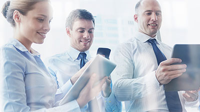 New Ways to Distribute Your Products Three Colleagues looking at different mobile devices